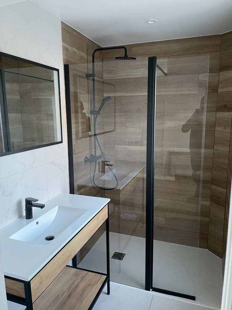 Photo d'une rénovation de salle de bain avec douche à l'italienne et faïence blanche et style bois